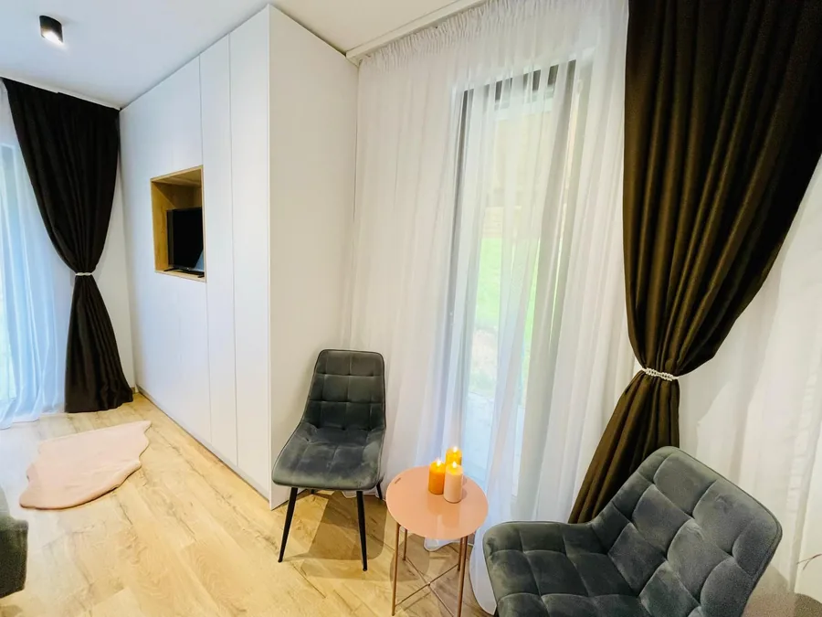 Cozy corner with velvet armchairs by the bedroom window